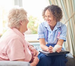 Image of a nurse talking to an elderly lady